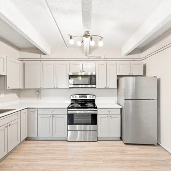 Julian Square Apartments kitchen with light gray cabinets