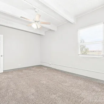 Julian Square Apartments primary bedroom with exposed beams
