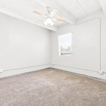 Julian Square Apartments carpeted bedroom with natural light